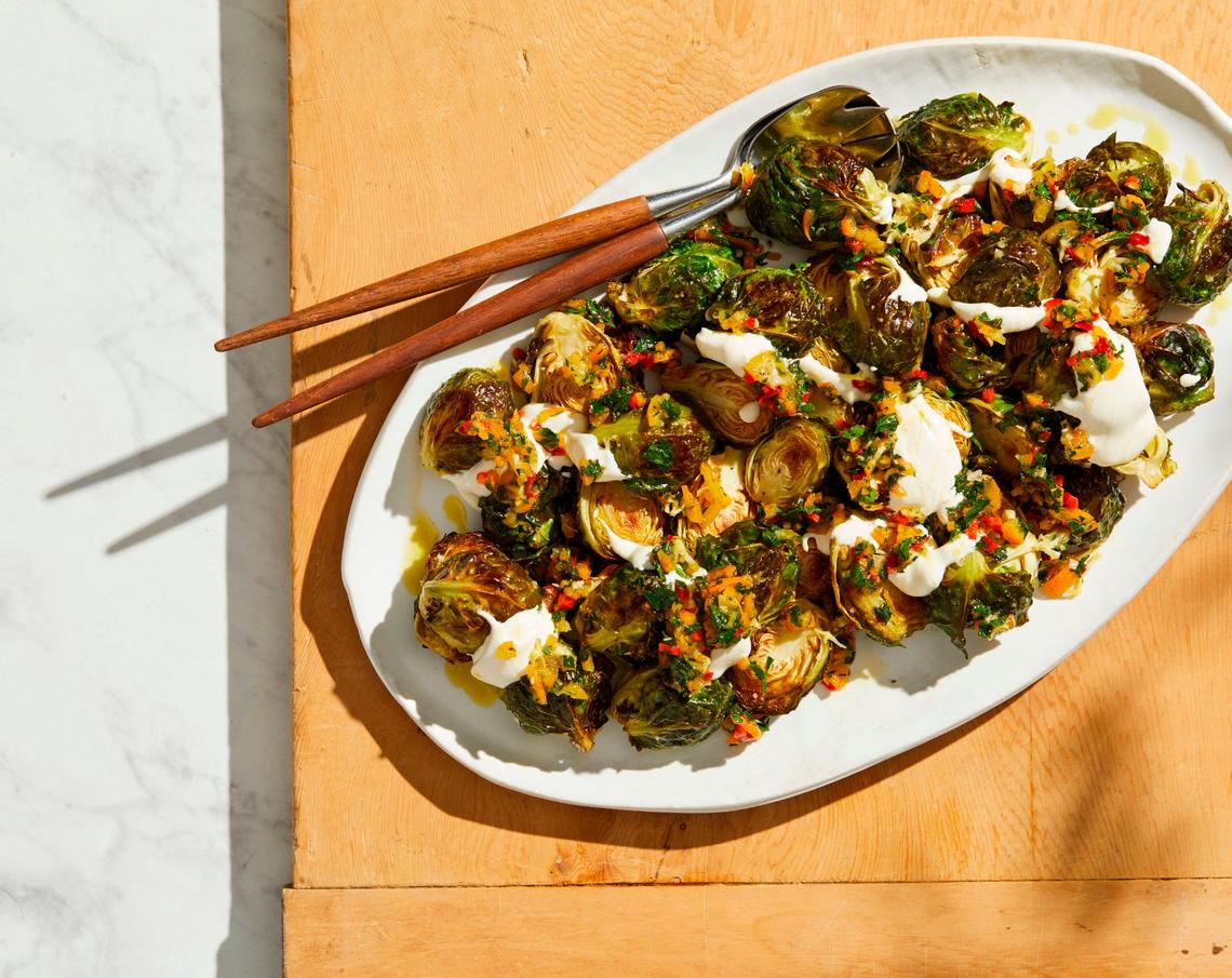 Roasted Brussels sprouts with kumquat relish and sour cream.