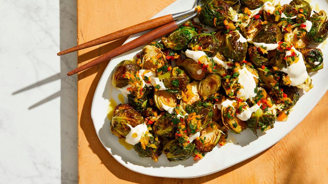 Roasted Brussels sprouts with kumquat relish and sour cream.