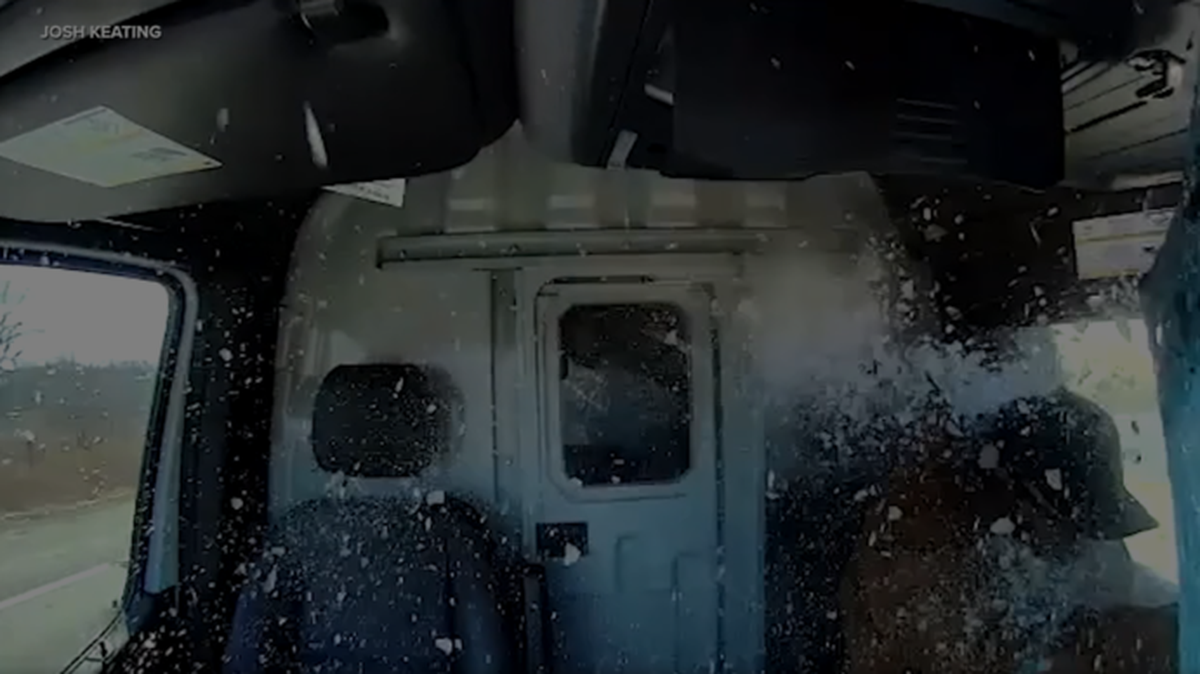 A screenshot of dashcam footage from Josh Keating’s work van when ice crashed through his windshield on the highway.