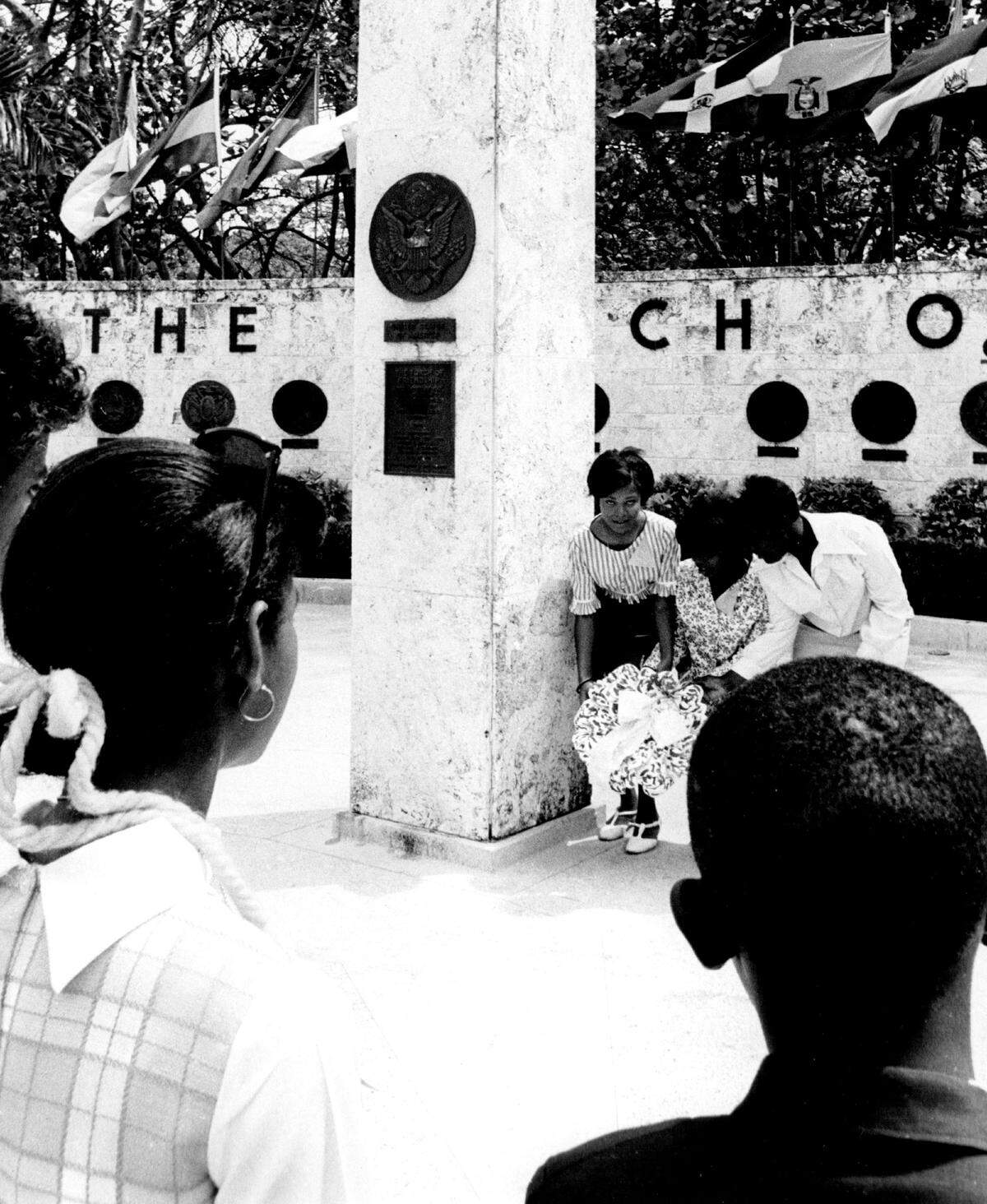 People place a wreath at the torch site.