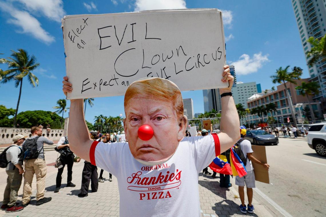 Protester Adamo G., wearing a Trump clown face with a red nose joins protesters during a ‘No Kings’ anti-Trump protest at the Torch of Friendship monument at Bayfront Park in Miami, Florida on Saturday, June 14, 2025.