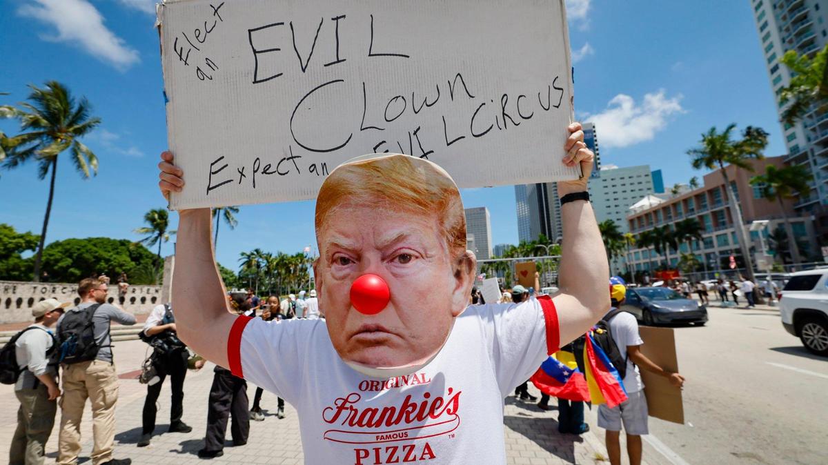 Protester Adamo G., wearing a Trump clown face with a red nose joins protesters during a ‘No Kings’ anti-Trump protest at the Torch of Friendship monument at Bayfront Park in Miami, Florida on Saturday, June 14, 2025.