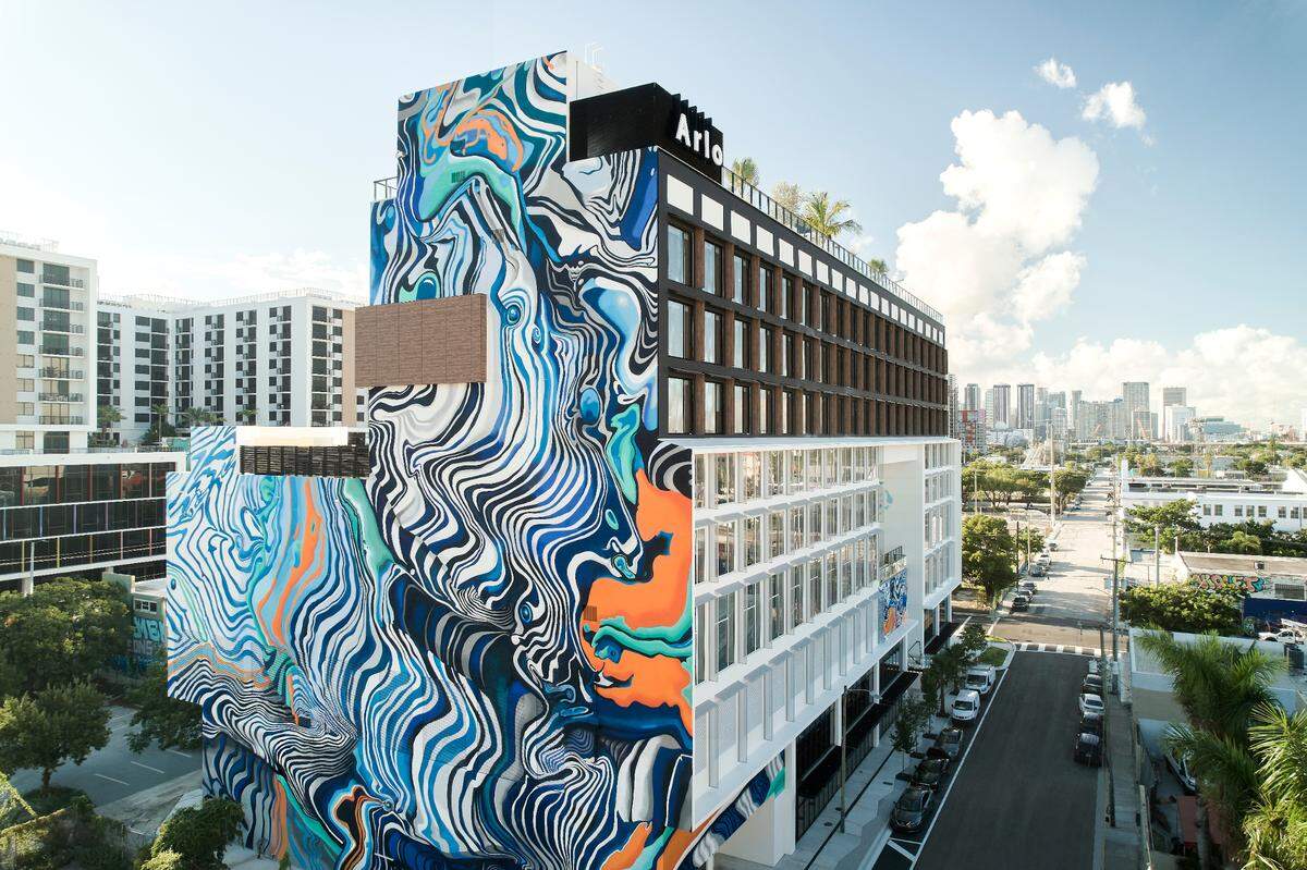 The exterior of Arlo Wynwood sports a mural by the Miami-based artist Hoxxoh.