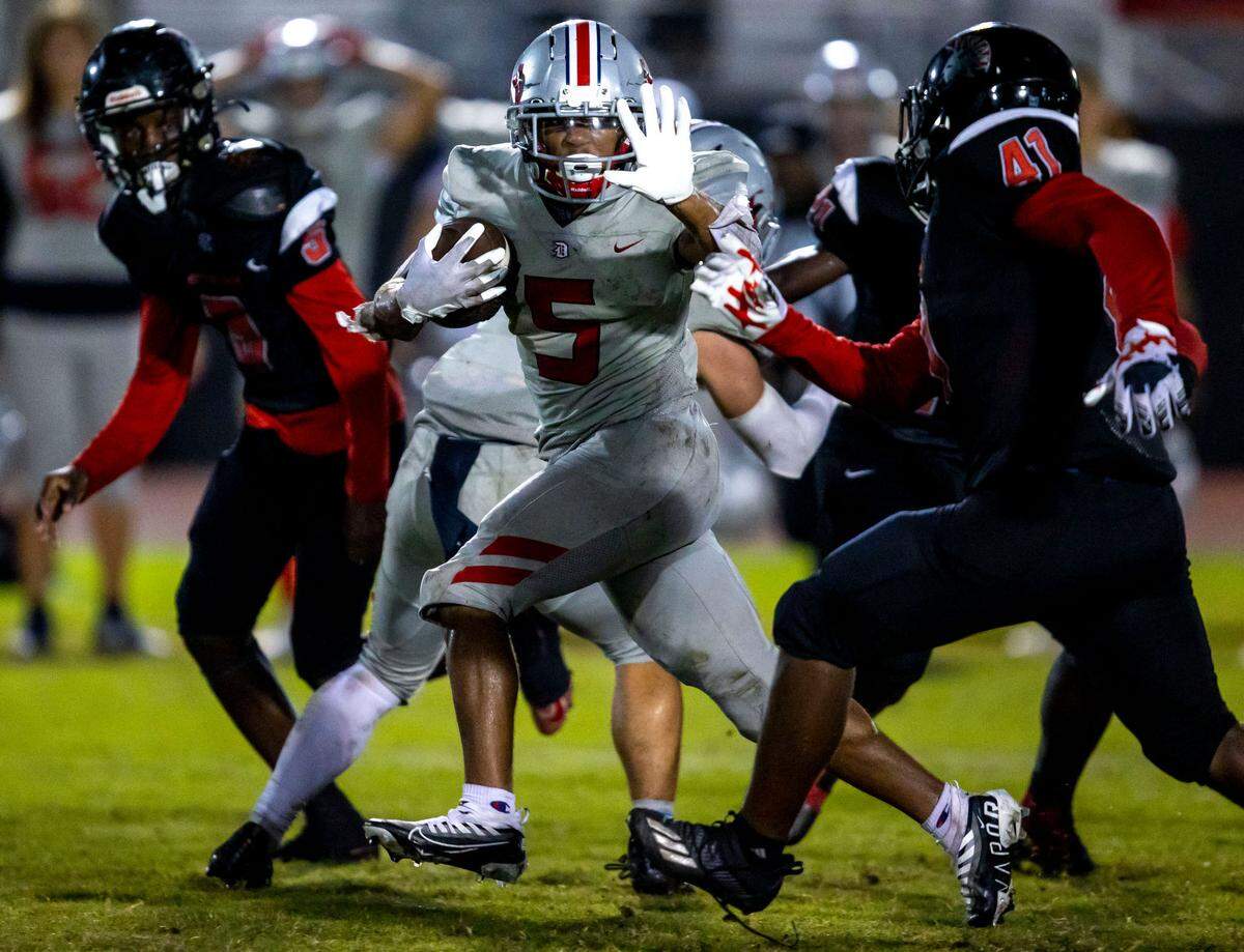Doral Academy running back Jason Demetrius (5) runs with the ball during the second half of an high school football game against Miami Southridge at South Ridge Park in Miami, Florida, on Friday, September 24, 2022.