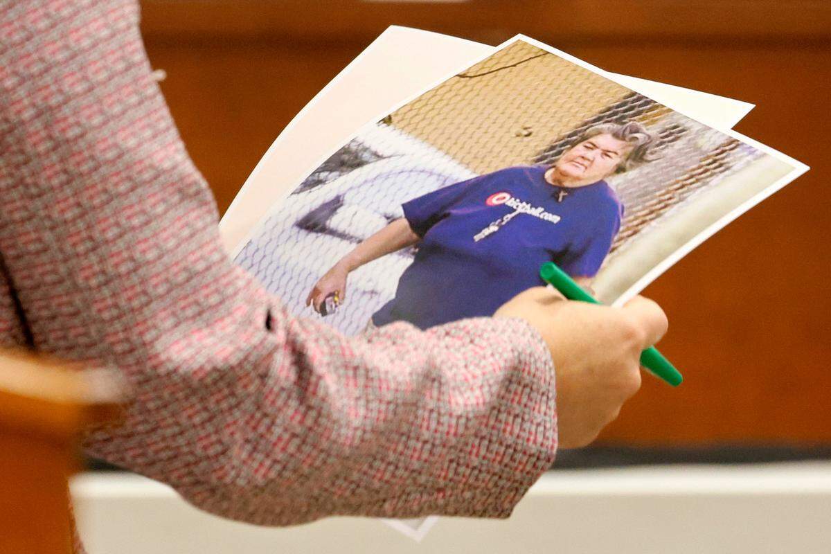 Assistant Public Defender Tamara Curtis carries photographs of Brenda Woodard, the biological mother of Marjory Stoneman Douglas High School shooter Nikolas Cruz, during the penalty phase of Cruz’s trial at the Broward County Courthouse in Fort Lauderdale on Monday, Aug. 22, 2022.