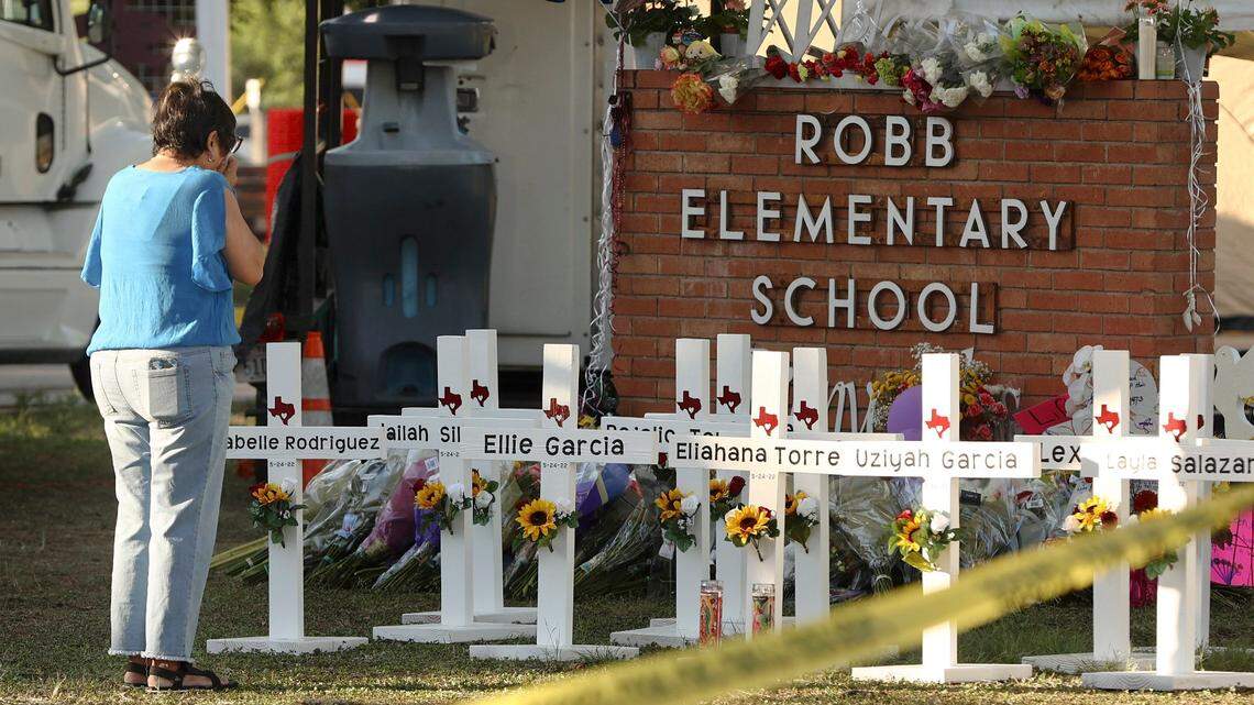 Dora Mendoza, grandmother to victim Amerie Jo Garza, wipes tears from her eyes as she pays respects to her granddaughter and others at a memorial site for the victims of the Robb Elementary School shooting, Thursday, May 26, 2022, in Uvalde, Texas. (Kin Man Hui/The San Antonio Express-News via AP)