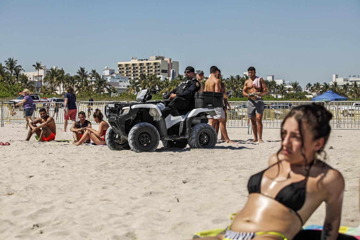 A Miami Beach officer sits on a four-by-four on South Beach as part of tougher policing during spring break due to the outbreaks of fights and increased alcohol and drug consumption on Friday, March 22, 2019.