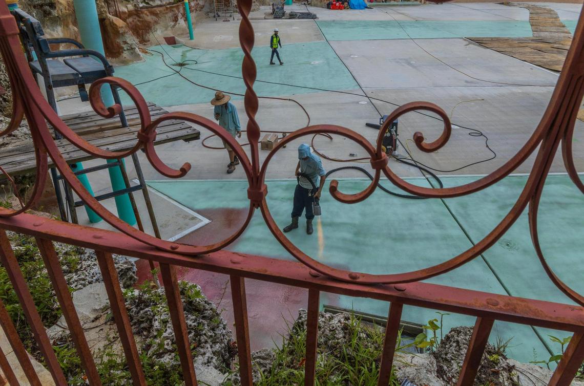 A worker is seen using a flamethrower to seal the pool bottom at the Venetian Pool in Coral Gables on Tuesday, July 22, 2025.