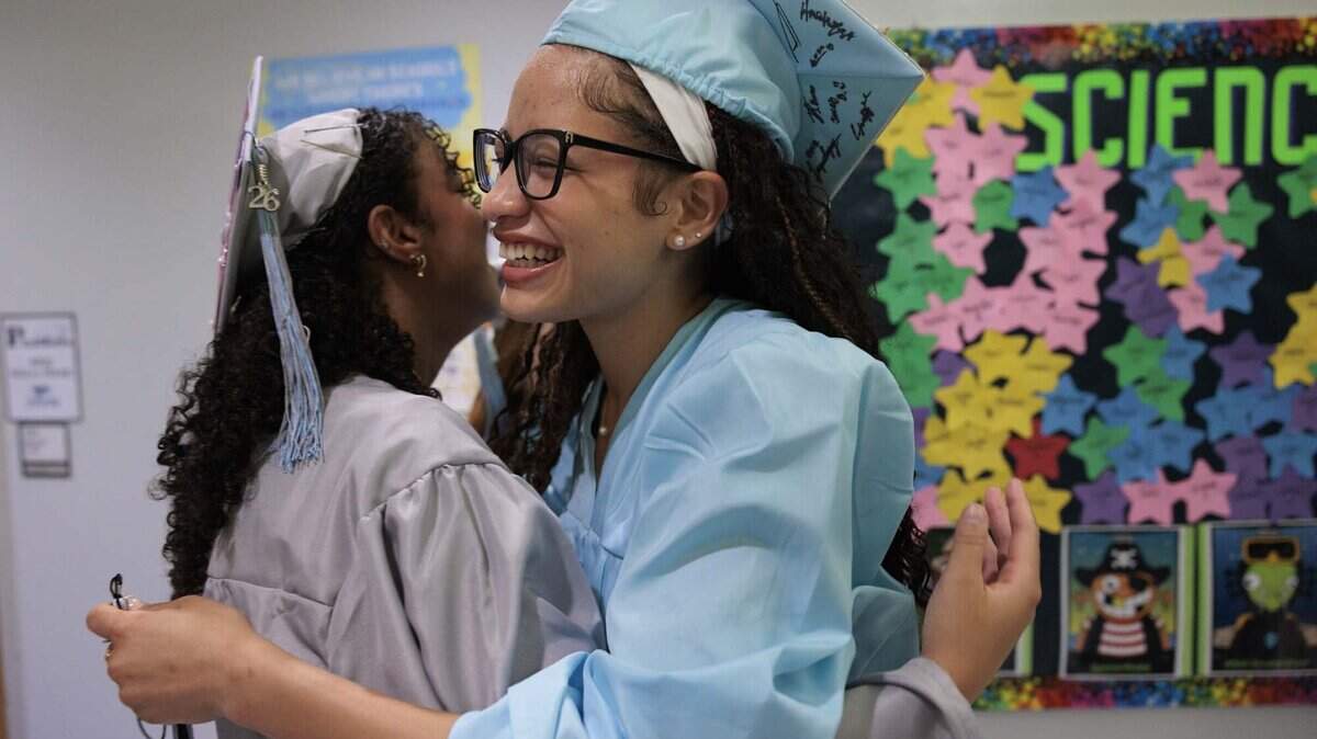 Adeola Alebiosu, right, who flew in from Illinois, hugs an old friend after the alumni walked through the halls of their elementary school, Panther Run Elementary, on Monday, June 1, 2026, in Pembroke Pines, Fla. The school invited graduating alumni, from as far as Illinois, to come and walk through their former elementary school to celebrate their high school graduation before it closes.