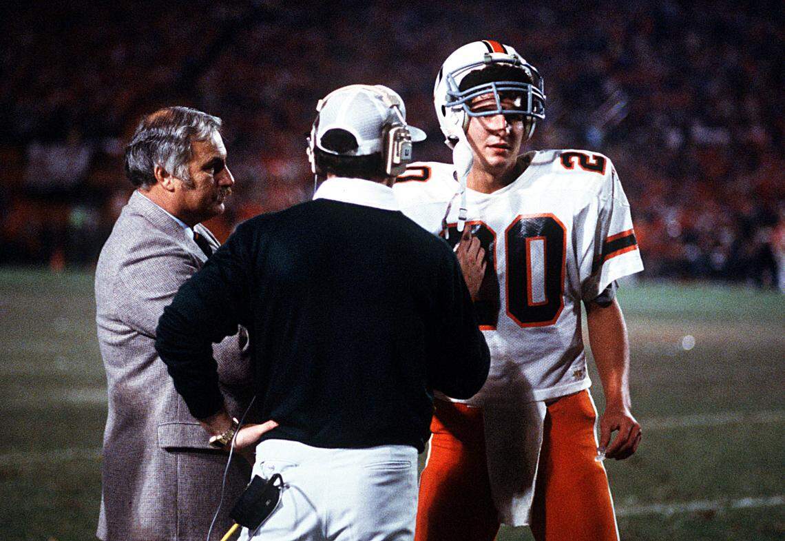 UM quarterback, Bernie Kosar talks with coaches during the 1984 Orange Bowl game.