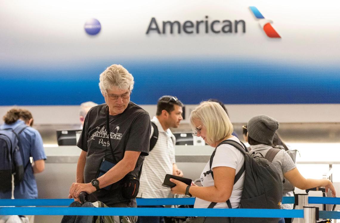 Travelers visit the American Airlines check-in area at the Miami International Airport on Monday, May 1, 2023, in Miami, Fla. Following four years of negotiations, the Allied Pilots Association agreed upon a strike authorization on behalf of American Airlines pilots.
