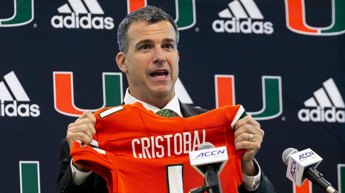 Mario Cristobal, the newly hired head football coach of the Miami Hurricanes, reacts after being given a jersey during a press conference at the Carol Soffer Indoor Practice Facility inside the University of Miami in Coral Gables, Florida on Tuesday, December 7, 2021.