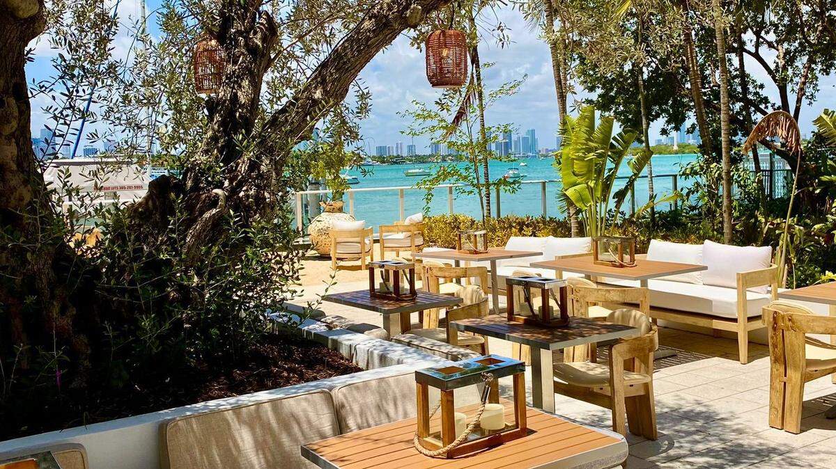 The outdoor patio at waterfront restaurant Pamplemousse on the Bay in Miami Beach.