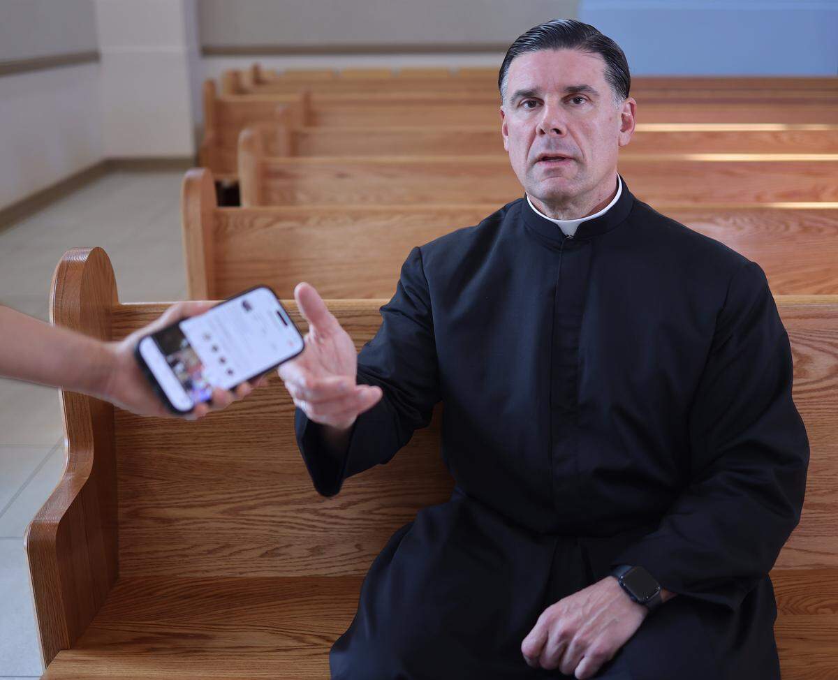 Father Rafael Capó, vice president of mission and ministry and dean of Theology at St. Thomas University, talks about the risks and responsibilities that come with embracing new technologies like AI in ministry. As a digital influencer in the Catholic church, Capó has dealt with scammers creating hundreds of fake profiles of himself over the years that were sent to his followers. Father Rafael Capó, is photographed inside St. Anthony Chapel at St. Thomas University in Miami Gardens, Florida, on February 17, 2026.