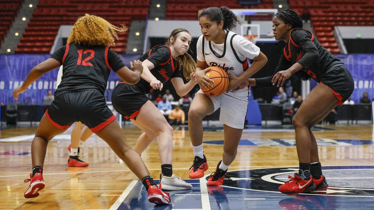 Southridge High School’s Sakura Barnes (1) battles against Bloomingdale defenders in the second half of the FHSAA Class 6A Girls High School Basketball State Championship.