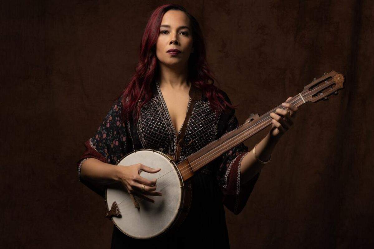 Rhiannon Giddens often plays a replica of a 19th-century fretless banjo, which has a deeper sound than the modern fretted instrument. It was a revelation to her when she first learned in her 20s that the banjo’s true origins were in Africa and the Caribbean. (Photo by Karen Cox/Courtesy Shorefire Media and The Rhythm Foundation)