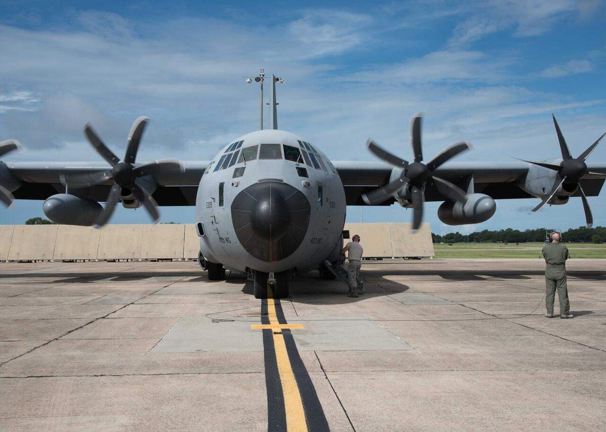 Tech. Sgt. Zahary Zieman, a loadmaster and dropsonde operator for the 53rd Weather Reconnaissance Squadron, assists the air crew with the engine startup prior to takeoff for a mission into Tropical Storm Chris on July 8.