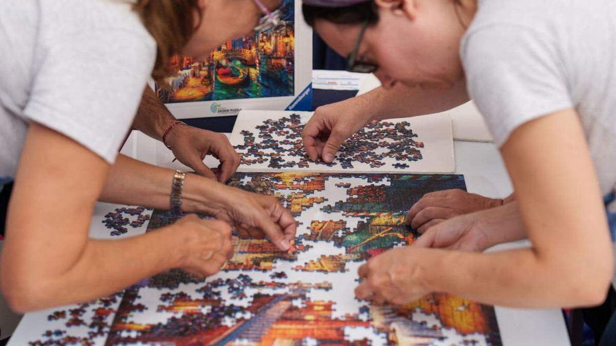 Participants compete in the fourth edition of the World Jigsaw Puzzle Championship in Valladolid on September 22, 2024. (Photo by CESAR MANSO / AFP) (Photo by CESAR MANSO/AFP via Getty Images)