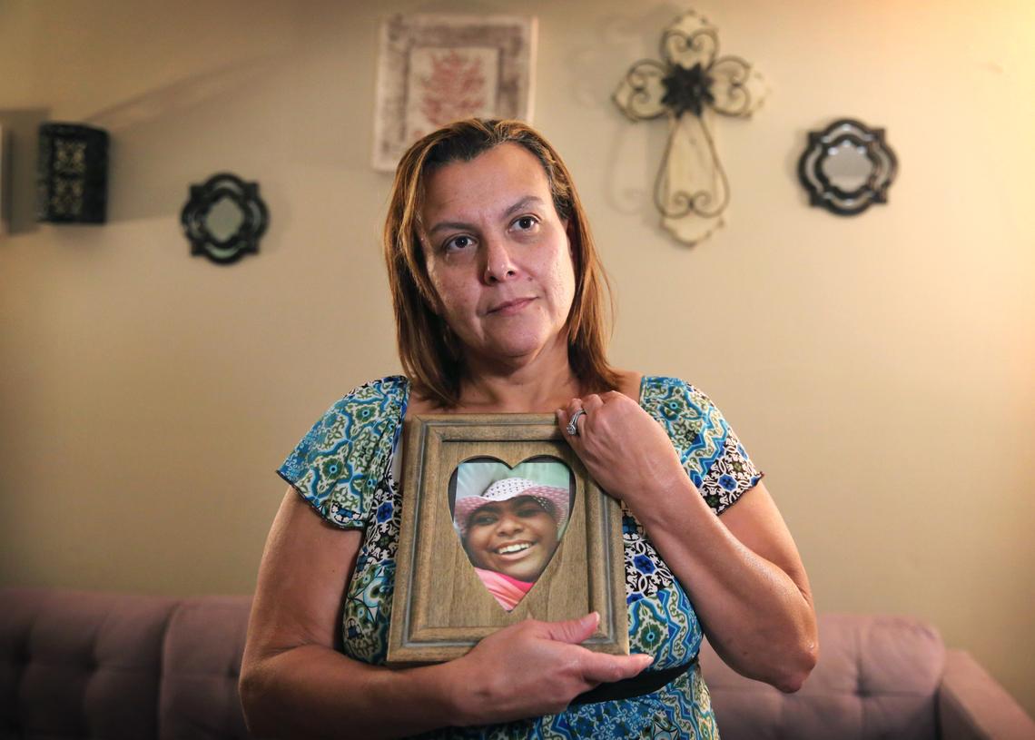 Jamie Acebo holds a favorite photograph of Jasmine, her first-born child.