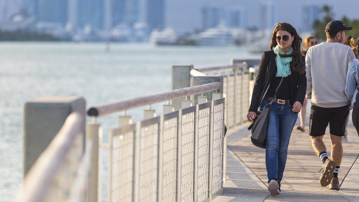 Tatiana Bezer, a resident of downtown Miami, walks down South Pointe Park Pier in Miami Beach on Monday, Jan. 28, 2019. Miami Beach is trying to attract more young people to the city.