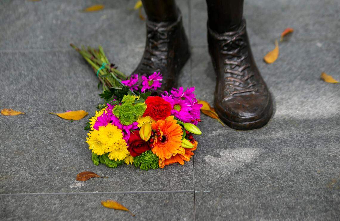 Flowers are placed at the base of a memorial at Florida International University in Miami on the fourth anniversary of the FIU bridge collapse on Tuesday, March 15, 2022. The bronze statue, which was made by Brian Hanlon, is of former FIU student Alexa Duran. The memorial also honors the other five victims who were killed when a pedestrian bridge, still underway, collapsed on March 15, 2018.