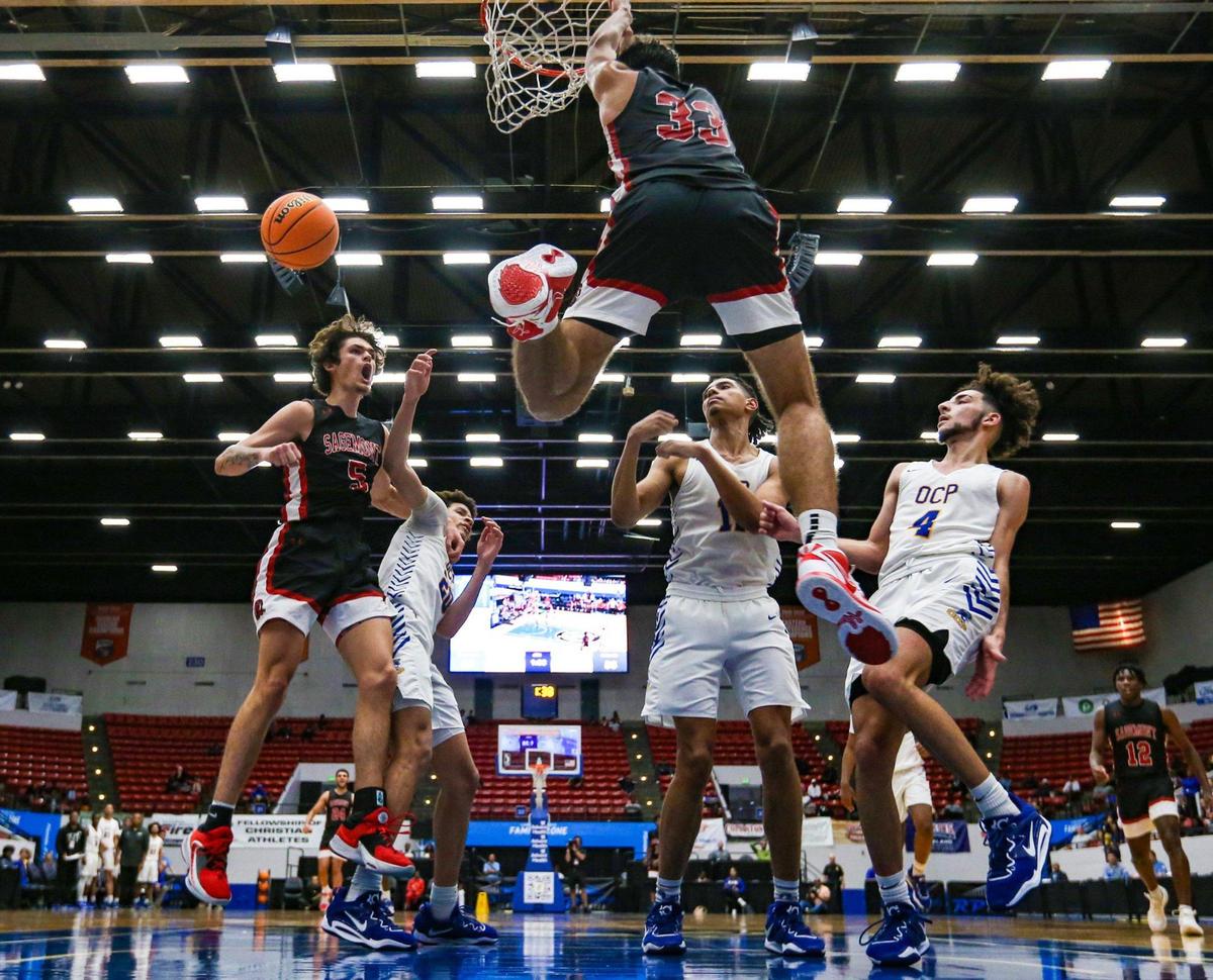 Sagemont High School’s Tynan Becker (5) reacts as Kenneth Lopez (33) alley-oop dunks the ball against Orlando Christian Prep during the second half of the FHSAA Class 2A Final at the RP Funding Center in Lakeland, Florida on Friday, March 3, 2023.