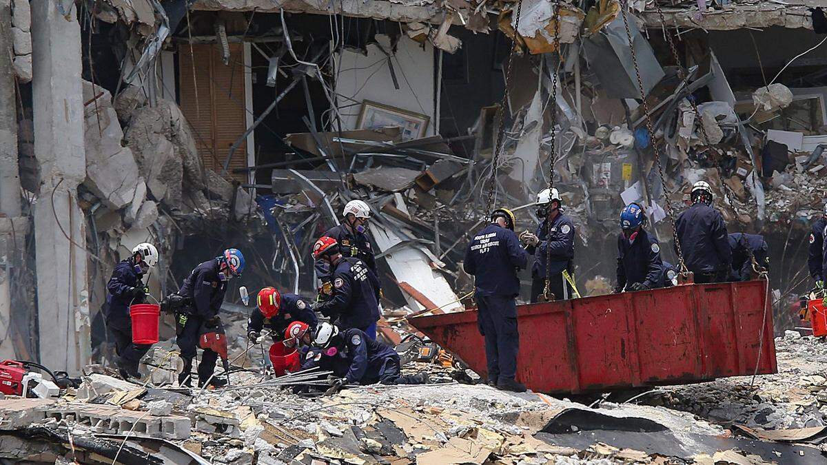 South Florida Urban Search and Rescue team members look for survivors at the collapsed oceanfront condo, Champlain Towers South in Surfside on Saturday, June 26, 2021.