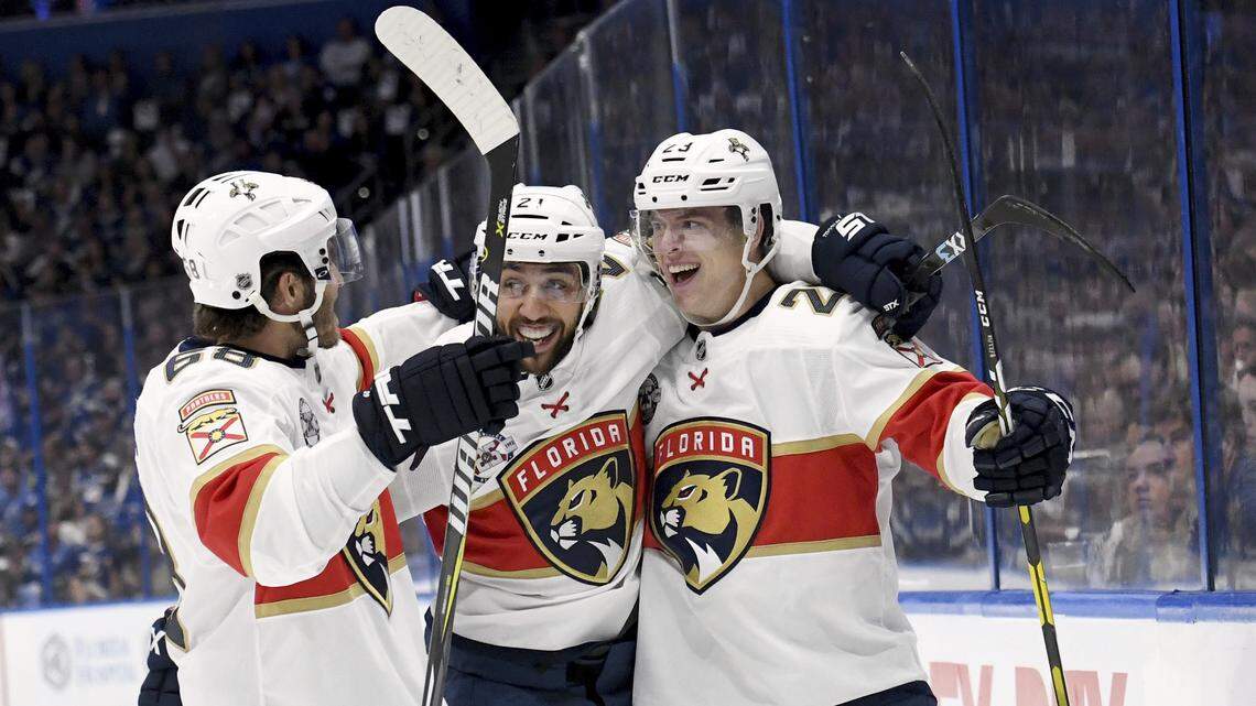 From left, Florida Panthers left wing Mike Hoffman, center Vincent Trocheck and defenseman Jacob MacDonald celebrate MacDonald’s goal during the first period against the Tampa Bay Lightning Saturday, Oct. 6, 2018, in Tampa, Fla.