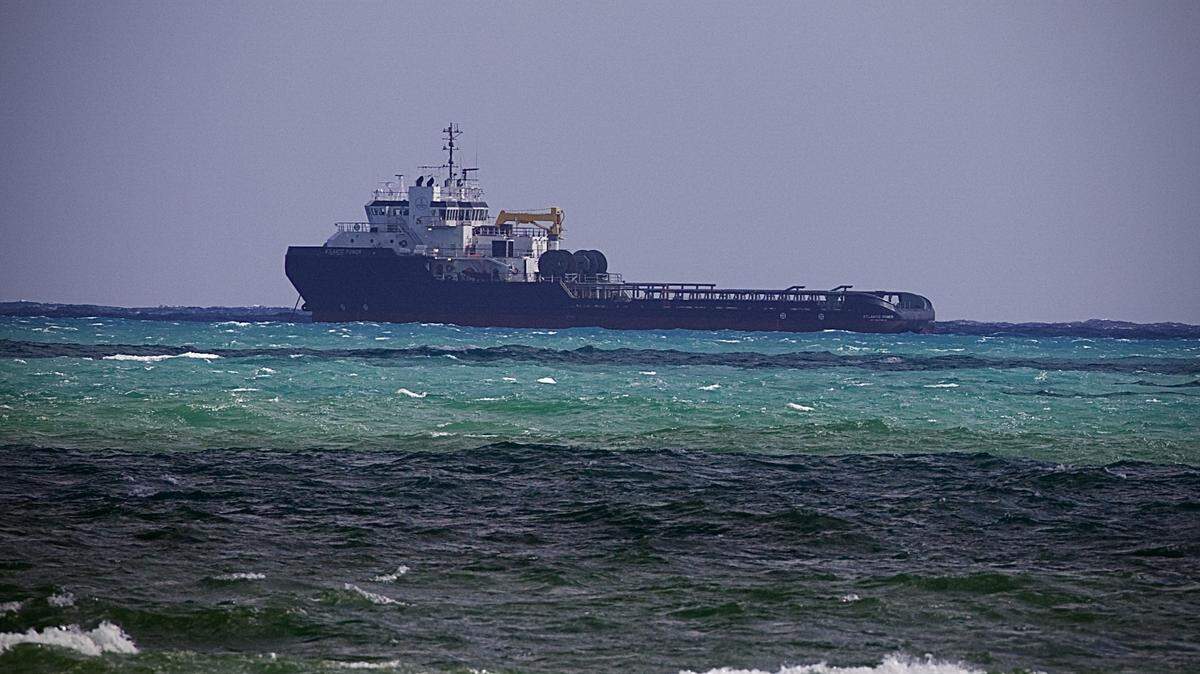 The Atlantic Power, a 250-foot anchor handling ship, floats idle off Government Cut in Miami Beach Tuesday, Oct. 22, 2024, after Miami-Dade Fire Rescue hoisted its captain from the vessel and took him to Ryder Trauma Center at Jackson Memorial Hospital.