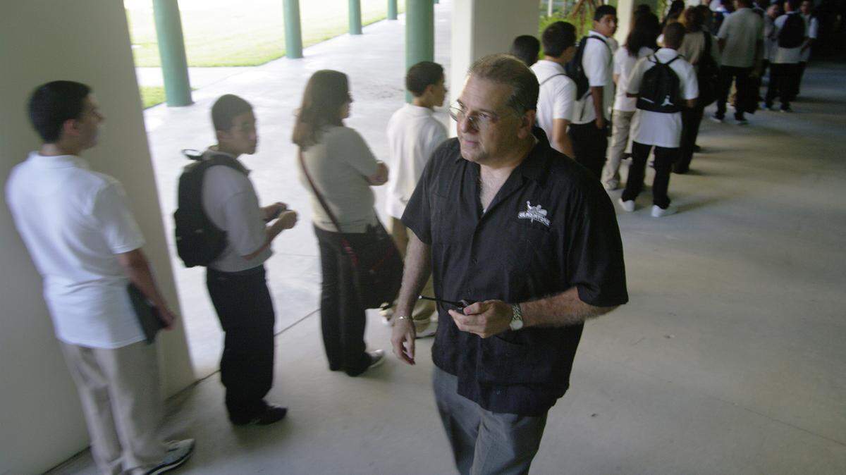 Principal Louis Algaze walks the halls during the first day of school at Hialeah Gardens High School in Hialeah, Aug. 24, 2009.