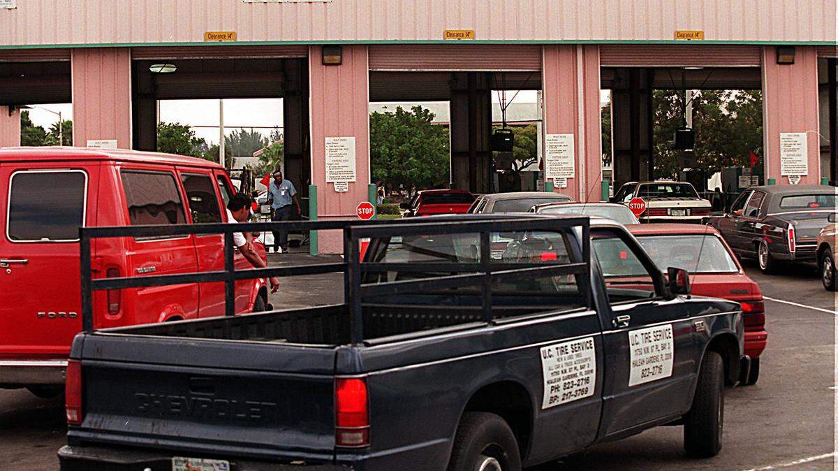 Cars line up at the auto Emissions inspection station at 13200 NW 42nd Ave.+