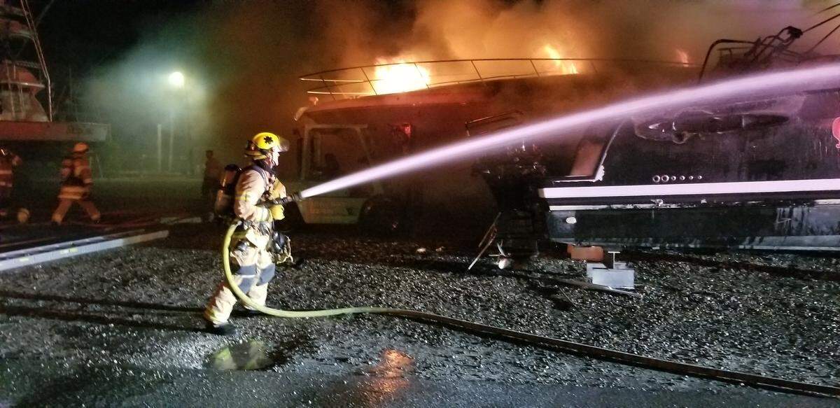 Islamorada Fire Rescue firefighters spray water on a boat at the Coral Bay Marina in Upper Matecumbe Key Monday morning, Feb. 11, 2019.