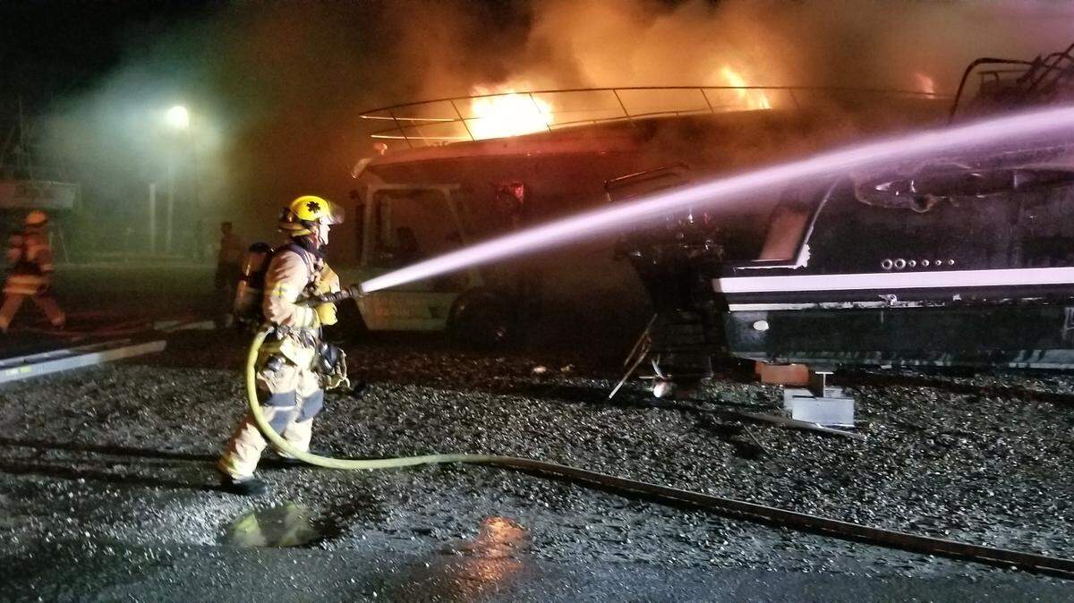 Islamorada Fire Rescue firefighters spray water on a boat at the Coral Bay Marina in Upper Matecumbe Key Monday morning, Feb. 11, 2019. Two boats in dry dock were destroyed by the fire.