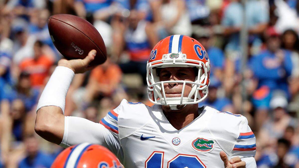Florida quarterback Feleipe Franks (13) throws a pass over defensive lineman Cece Jefferson, left, during an NCAA college spring football intrasquad game, in Gainesville, Fla.