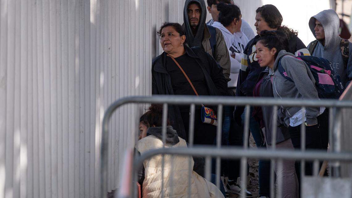 In this file photo, asylum seekers wait for news on their appointments with U.S. authorities before crossing through El Chaparral port in Tijuana, Baja California state, Mexico, on Jan. 20, 2025. 