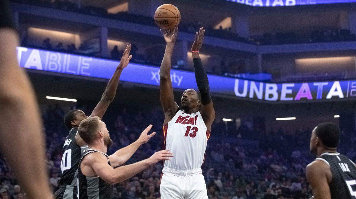 Miami Heat center Bam Adebayo (13) shoots over Sacramento Kings defenders during the first quarter of an NBA basketball game in Sacramento, Calif., Saturday, Oct. 29, 2022.