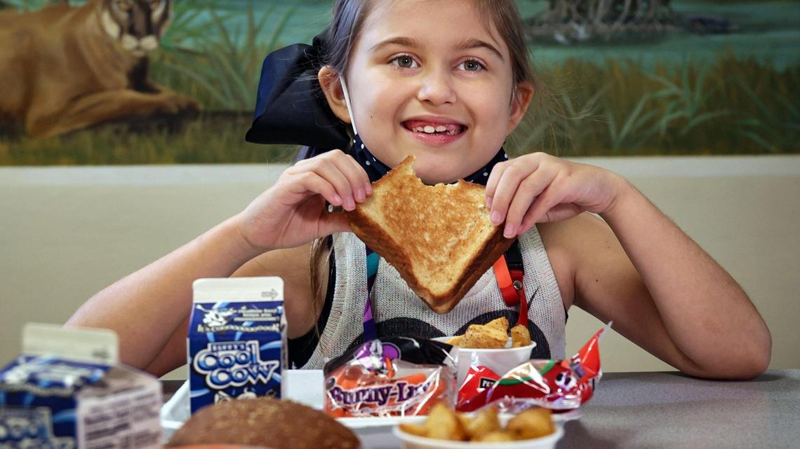 Heron Heights Elementary School third grader Margot McCormack samples a grilled cheese sandwich as part of the school lunch offering at the Parkland, Florida, school during the summer session.
