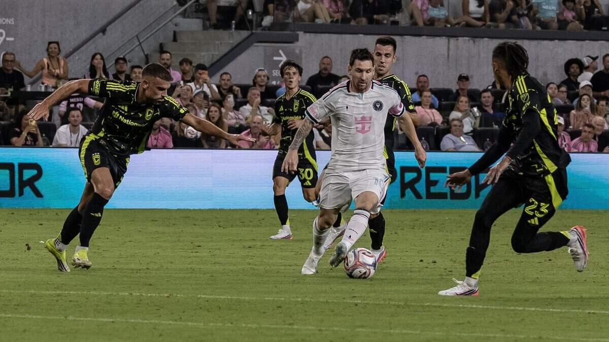 Inter Miami forward Lionel Messi (10) dribbles the ball against Columbus Crew defender Mohamed Farsi (23) and defender Rudy Camacho (4) in the second half of their MLS match at Nu Stadium on Saturday, Aug. 1, 2026, in Miami, Fla.