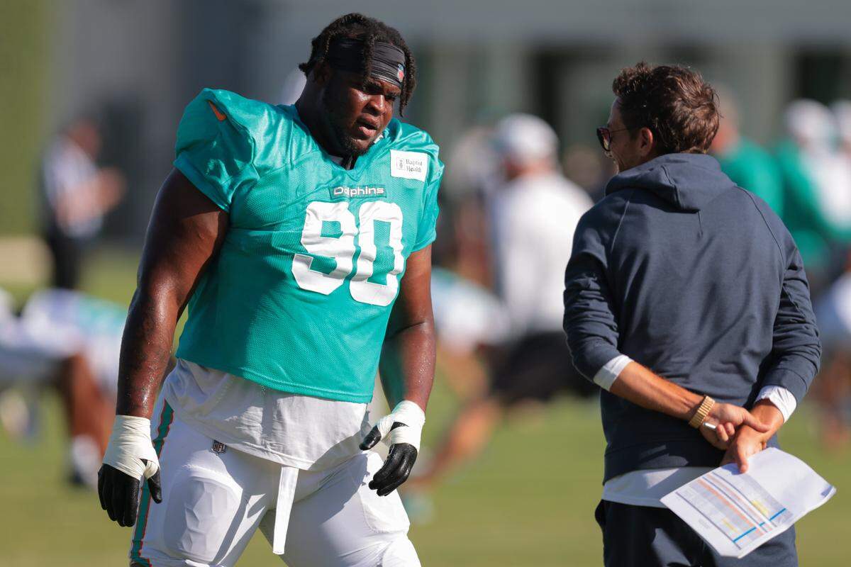 Miami Dolphins defensive tackle Kenneth Grant (90) speaks to head coach Mike McDaniel during training camp at Baptist Health Training Complex on Wednesday, July 30, 2025. 