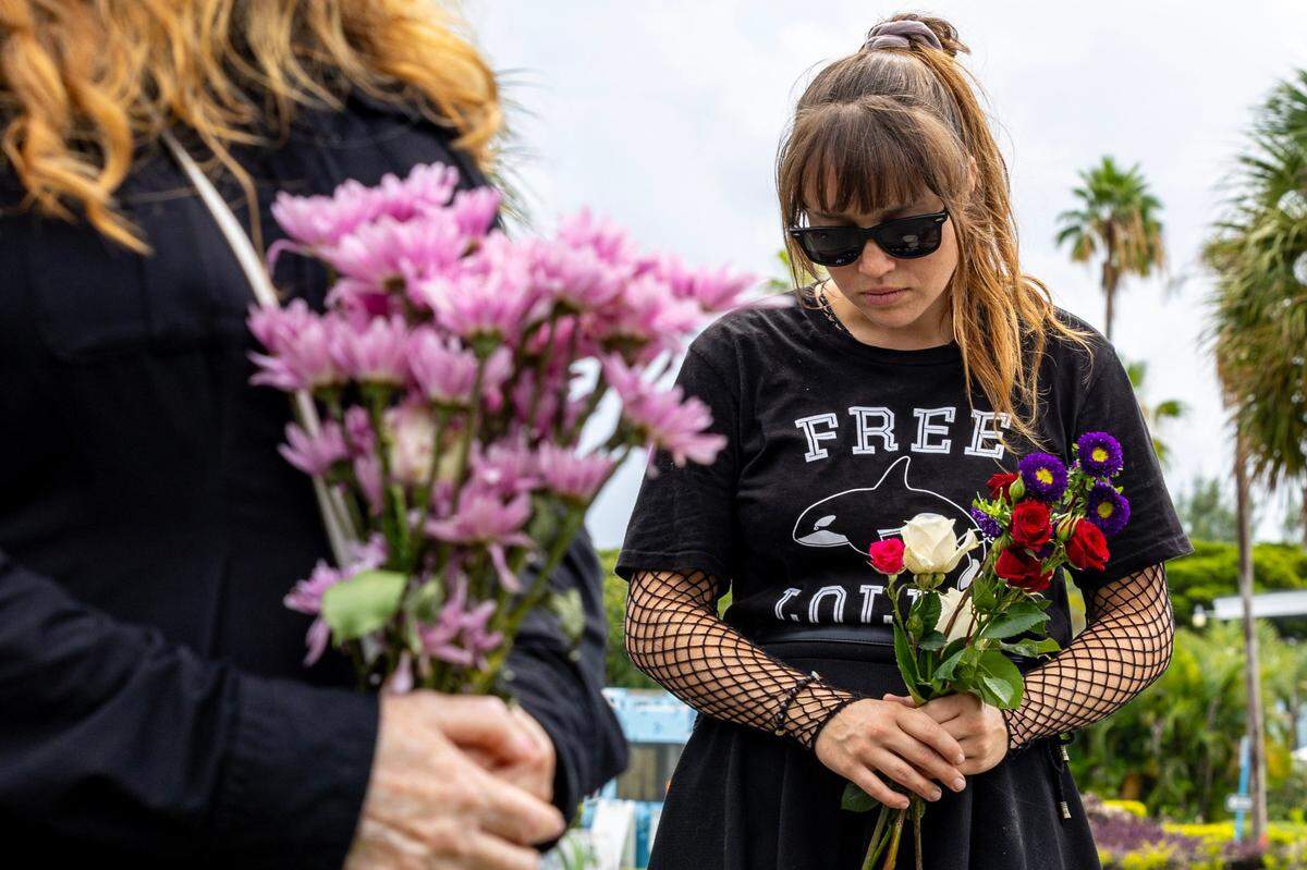 Anti-animal cruelty activist Keepurr reacts during a vigil hosted by PETA for Lolita the killer whale, also known as Toki, outside Miami Seaquarium in Key Biscayne, Florida, on Saturday, August 19, 2023. Toki died from suspected renal failure on Friday after decades of captivity since the age of four.
