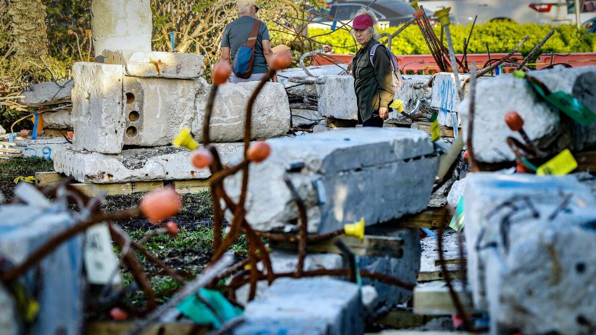 Susan Basow looks over the remnants of the Champlain Towers on display during a Moment of Reflection marking the transition into the next phase of the Champlain Towers South Memorial project at Veterans Park, in Surfside, Florida on Wednesday, February 4, 2026.