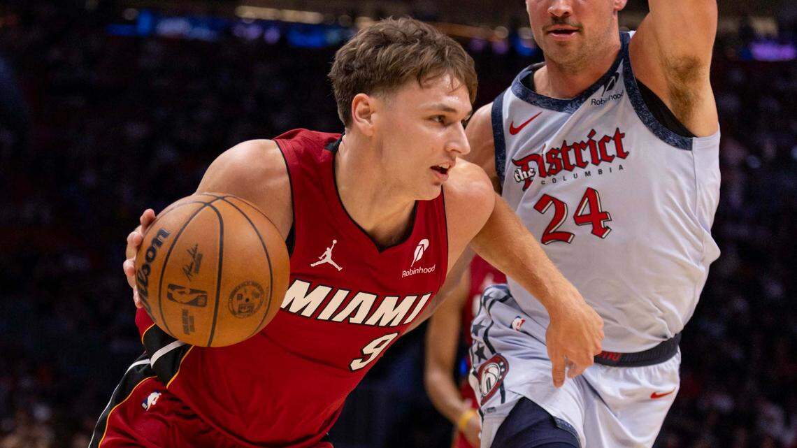 Miami Heat guard Pelle Larsson (9) drives on Washington Wizards forward Corey Kispert (24) during the second half of an NBA game at Kaseya Center on March 3, 2025, in Miami.