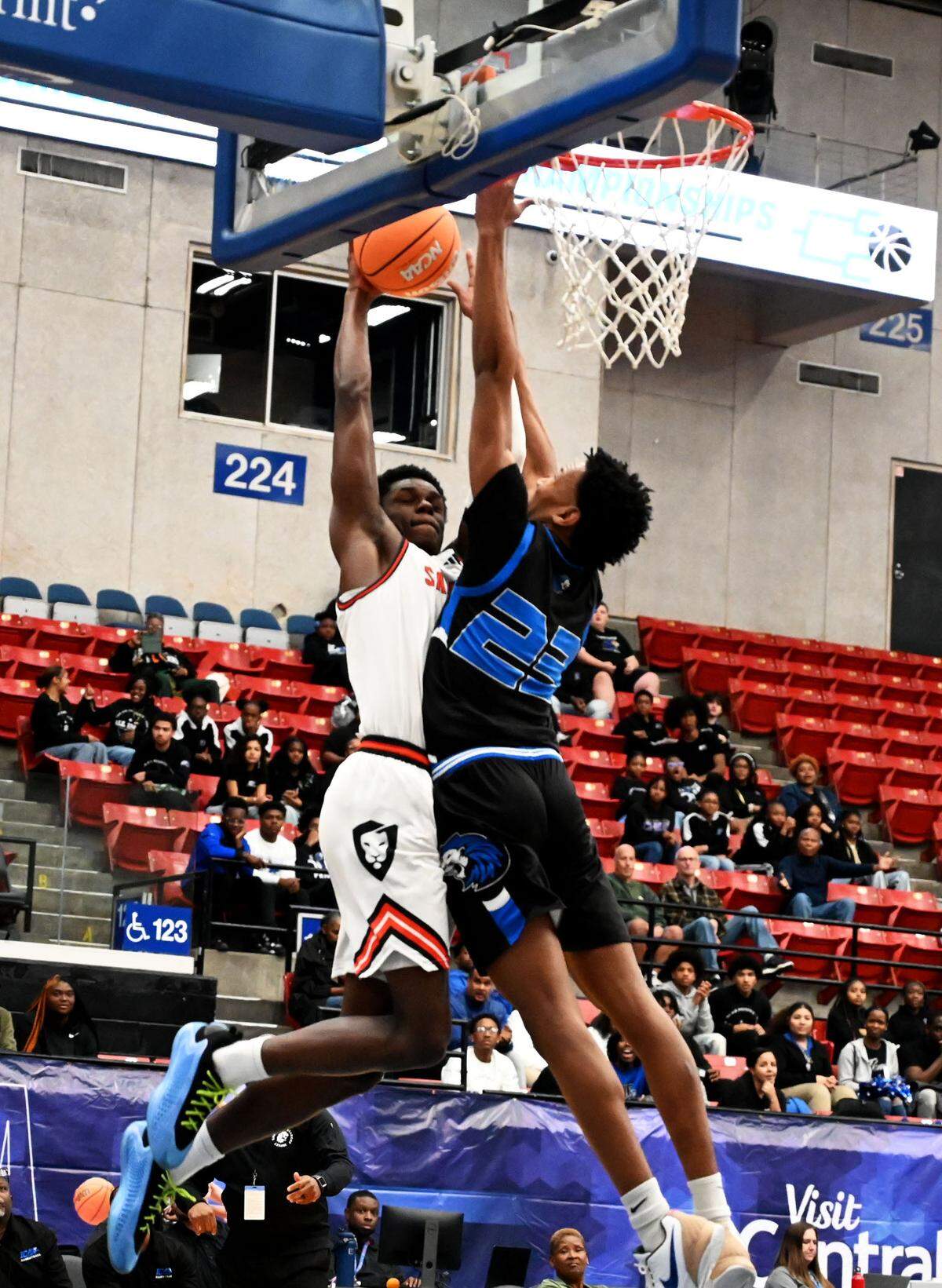 Sagemont junior forward Kevin Thomas (4) goes up strong to the basket while defended by Jacksonville Impact Christian point guard Ronald Clark on Tuesday during an FHSAA Class 1A state semifinal at the RP Funding Center in Lakeland.