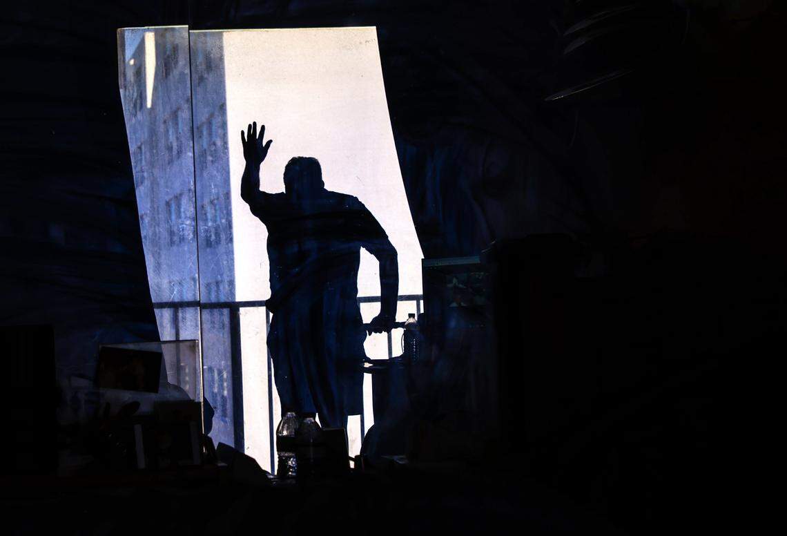 Bill Sarille, recovering from back surgery, gazes out from his ninth-floor Miami Beach apartment, reflecting on the rising fees, property taxes, and insurance costs that may force him to leave his home on Monday, July 28, 2025, in Miami Beach, Florida. Bill Sarille has lived in South Beach for nearly 30 years. On a fixed income, he struggles to afford his condo's rising maintenance costs and insurance premiums. 