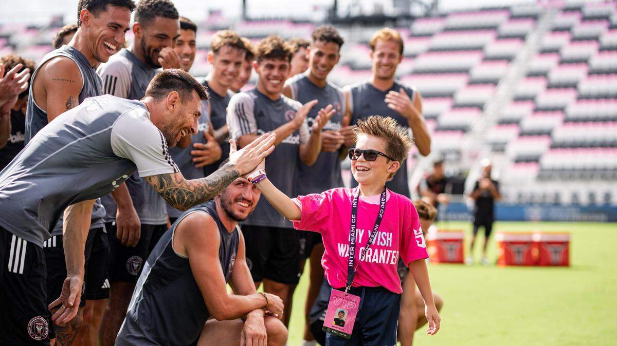 Inter Miami captain Lionel Messi (high-fiving in the foreground) and his teammates granted the wishes of 23 critically ill children as part of a Make-A-Wish event at Chase Stadium on Tuesday, Sept. 24, 2024.