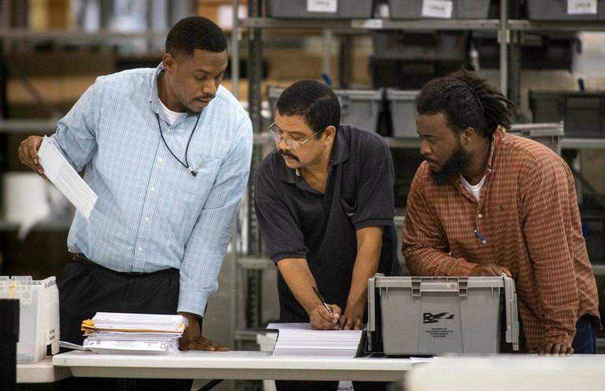 Election workers sort ballots at the Supervisor of Elections Service Center in Riviera Beach on Wednesday, Nov. 14, 2018.