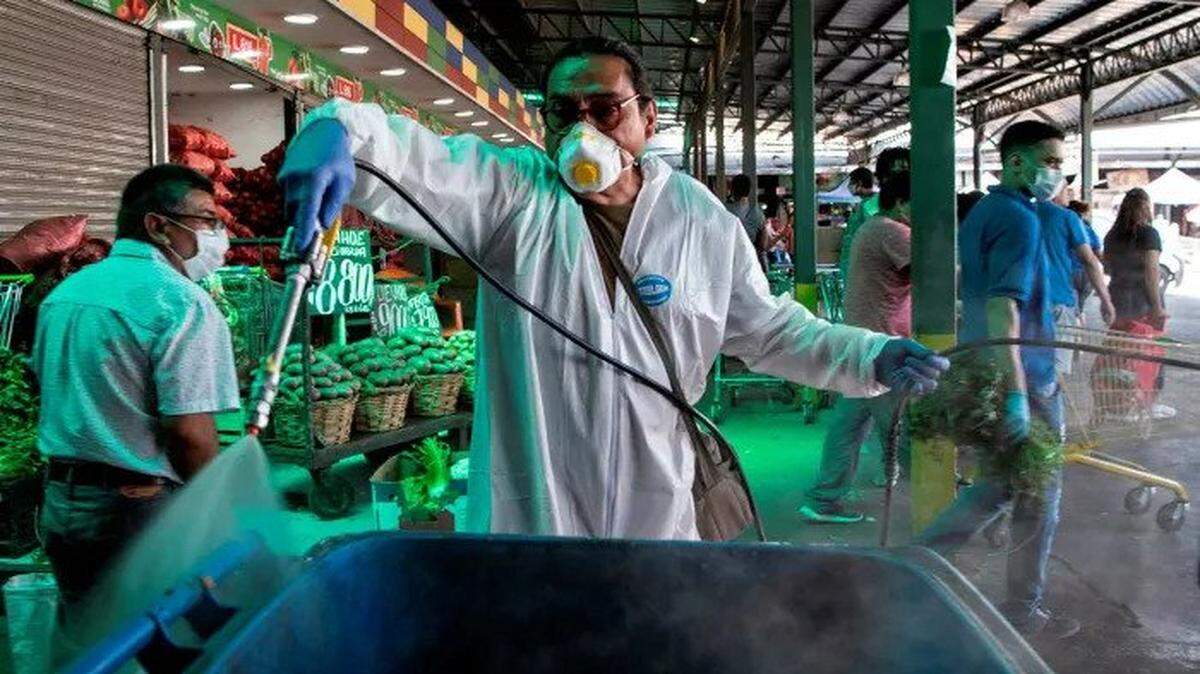 A municipal worker disinfects the central market in Chile’s capital.