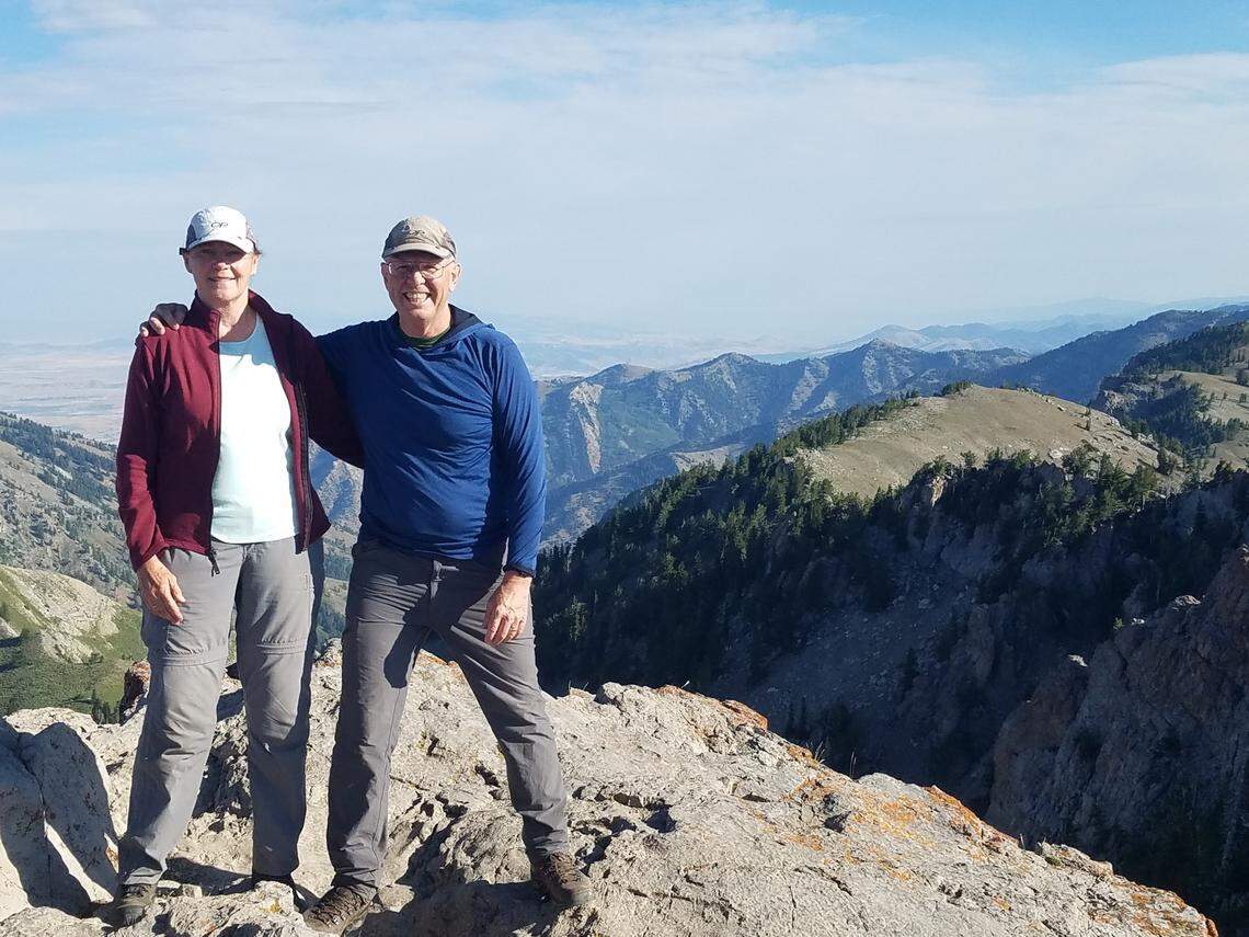 Dave and Beckie Covill stand atop Naomi Peak, the highest point in Cache County, Utah, in 2022.