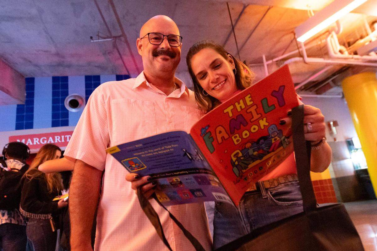 Yamiely and Leonardo Rayon of Coconut Grove read their new book, ‘The Family Book,’ which has been restricted in at least three Florida school districts, including Okaloosa County.