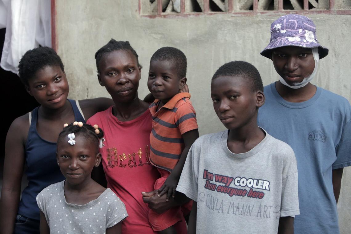 Djooly Jeune (far right) was finally diagnosed with Burkitt lymphoma after several doctors told his mother he had a dental problem. His illness weighed heavily on siblings, Estherlineda, Josieanne, Moise, 3 (being held by mom Angena Altidor) and Jhony Jeune.